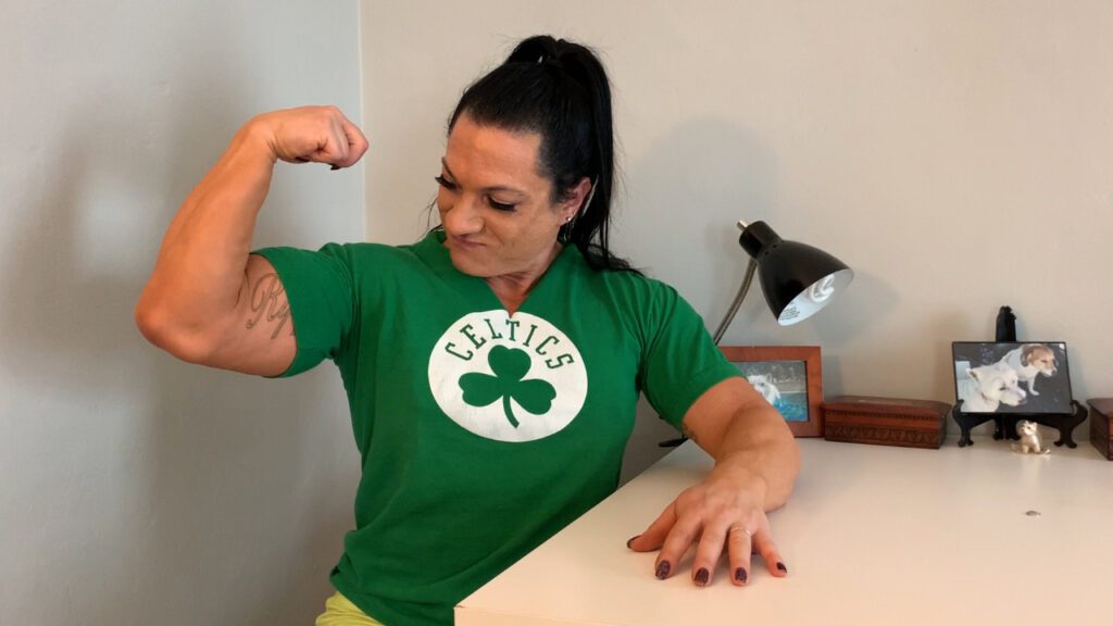 RippedVixen, Green Celtics Shirt, flexing right bicep, intimidating